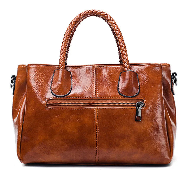 Pia | "Elegant leather handbag with braided handle".-Elly Rose